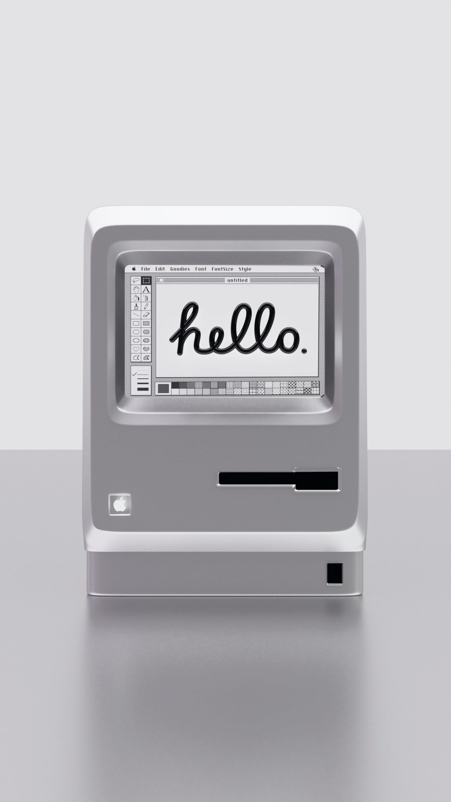 A vintage Macintosh computer displaying the word hello